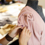 female-dressmaker-attach-fabric-mannequin-with-needles-creating-dress-design_105751-2873