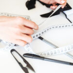 close-up-seamstress-working-with-measuring-tape_171337-7349